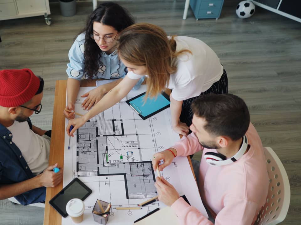 Team reviewing site plans at a table