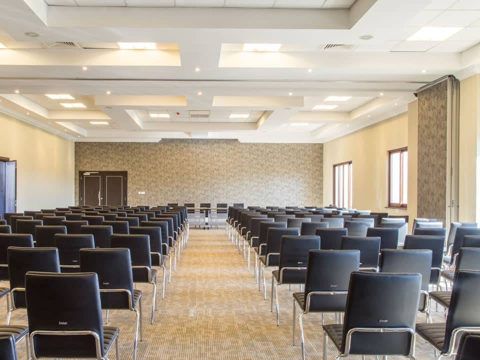 Meeting hall with rows of empty chairs